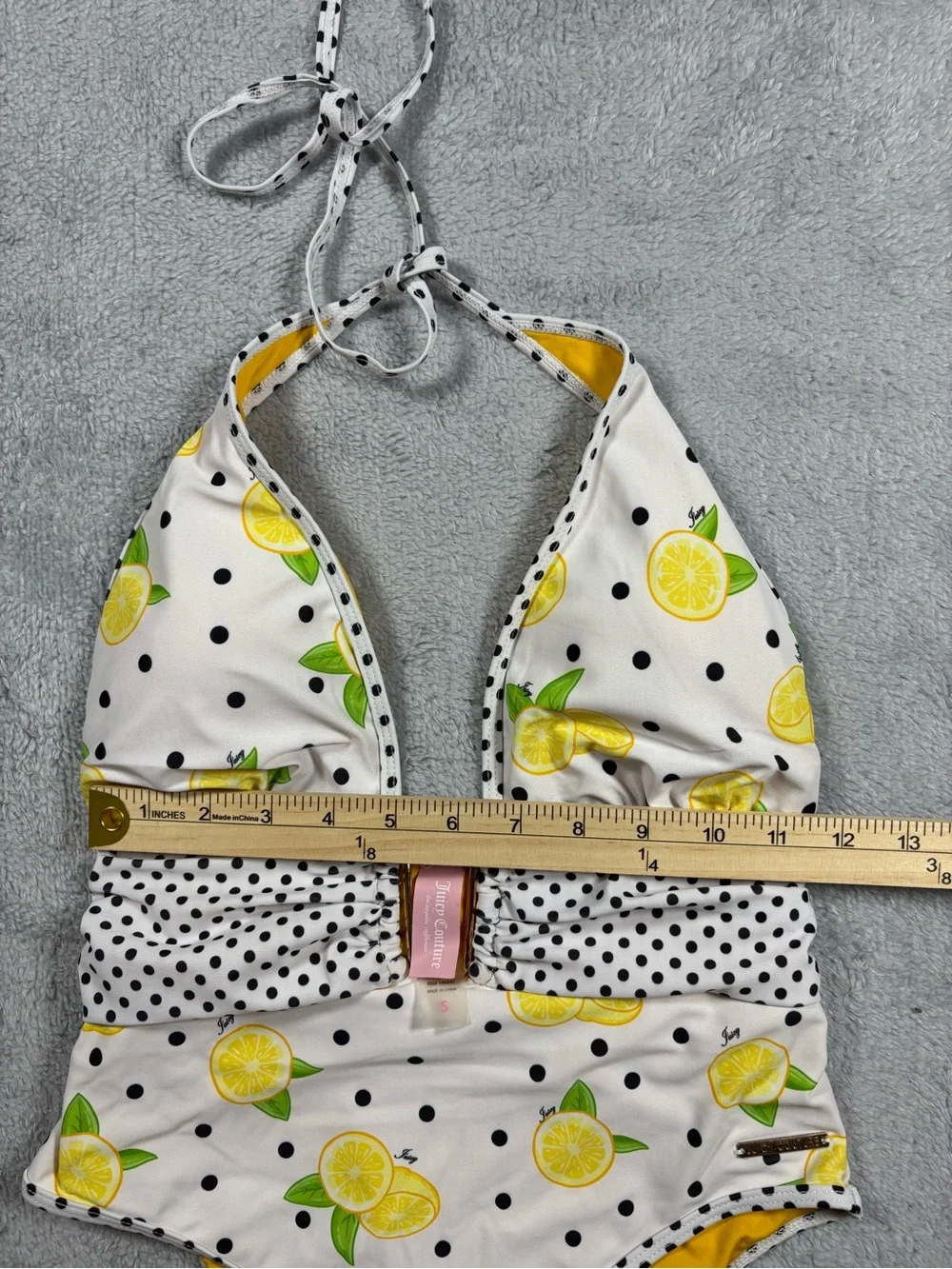 Juicy Couture yellow and white polka dot one piece swimsuit.